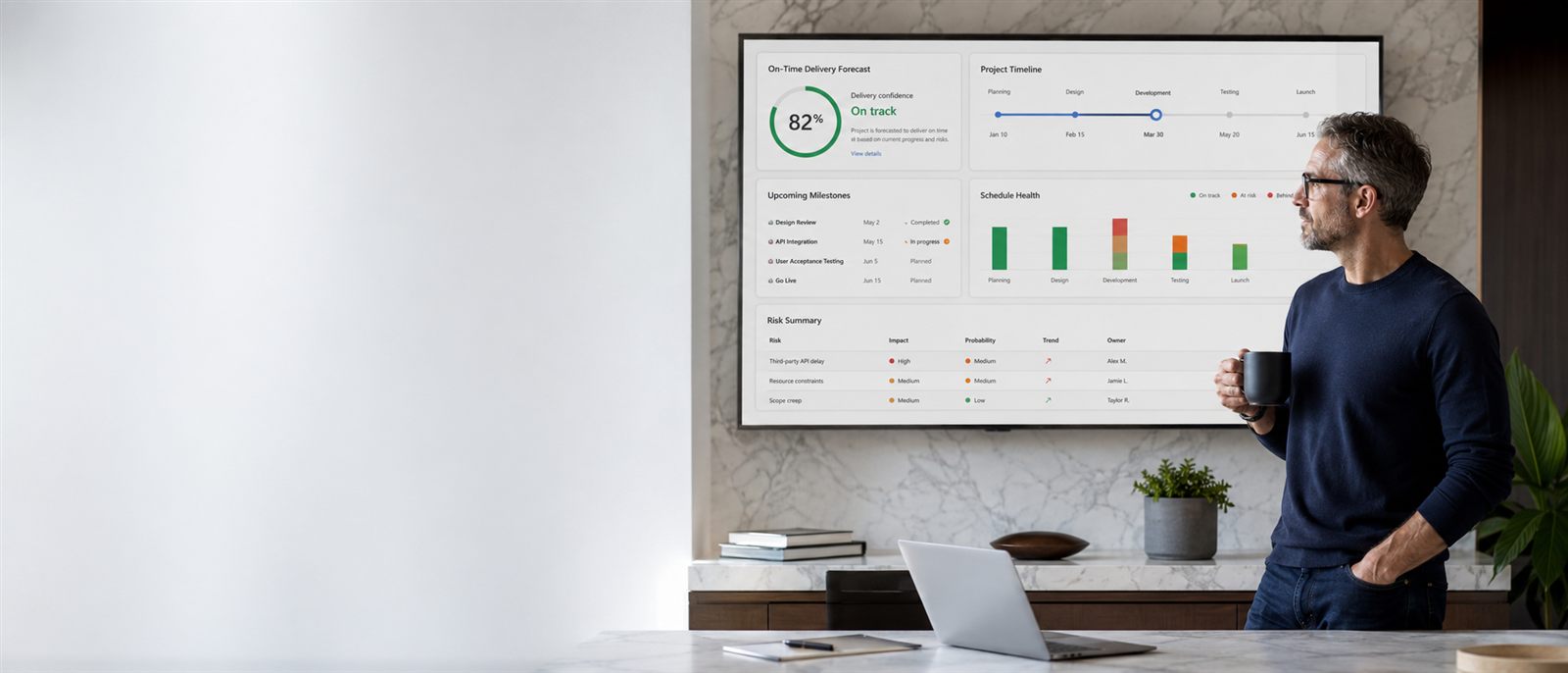 Program executive reviewing an on-time delivery forecast dashboard on a wall display